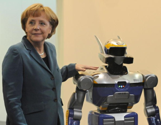 Illustration for article titled Why Is Angela Merkel Always Palling Around With Robots?